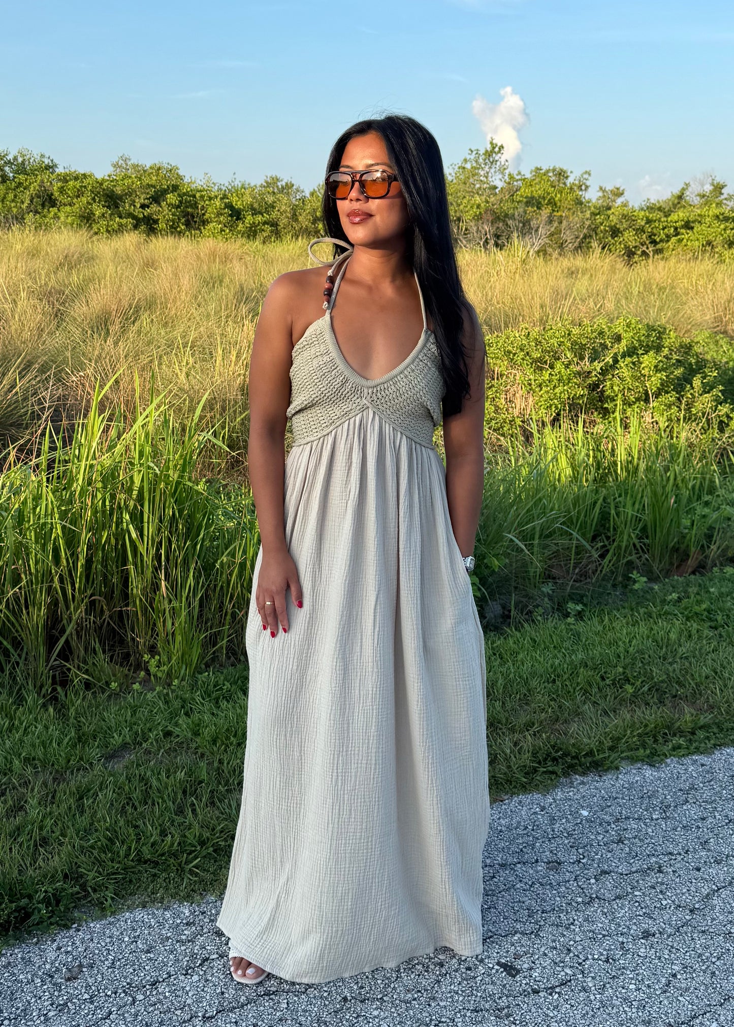woman wearing a long maxi dress on a grass background