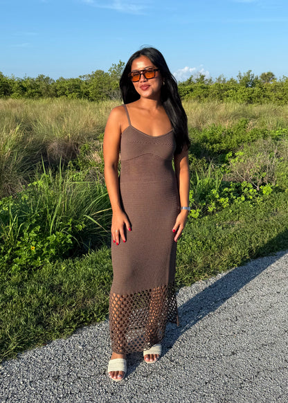 woman wearing a brown dress on a grass background
