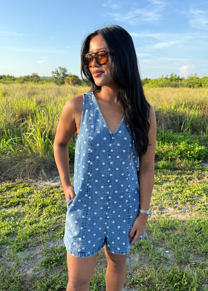 Girl wearing Millie Polka Dot Romper in Denim with grass background