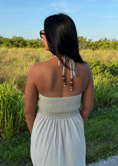woman wearing a long maxi dress on a grass background
