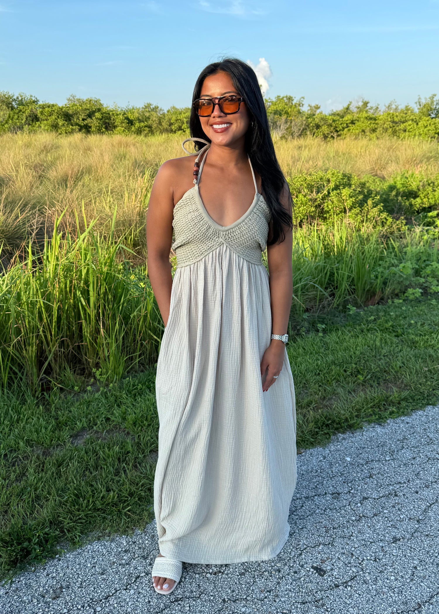 woman wearing a long maxi dress on a grass background