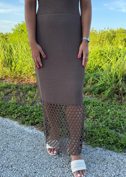 woman wearing a brown dress on a grass background