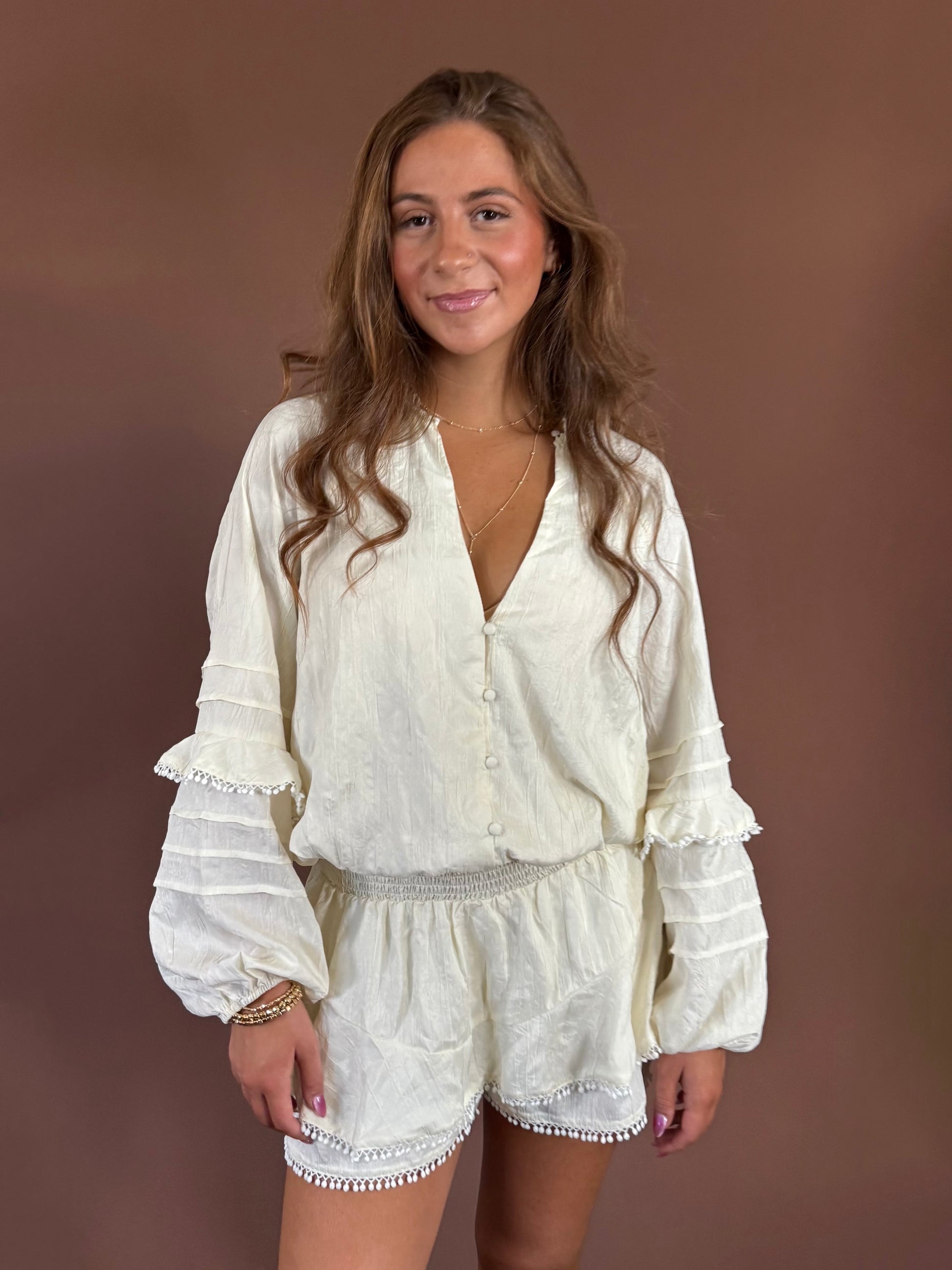 Aurora Long Sleeve Smocked Ruffle Romper in Ivory