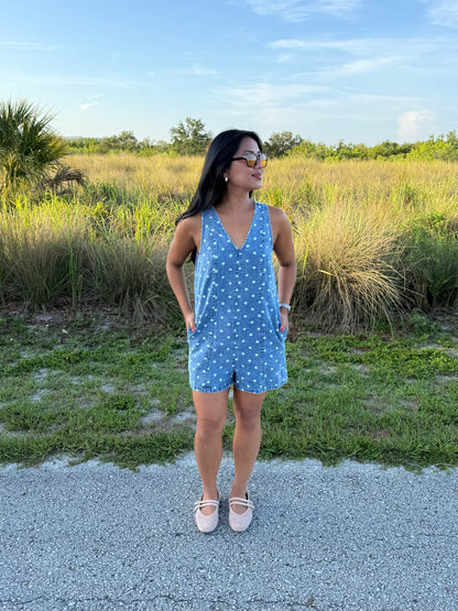 Girl wearing Millie Polka Dot Romper in Denim with grass background
