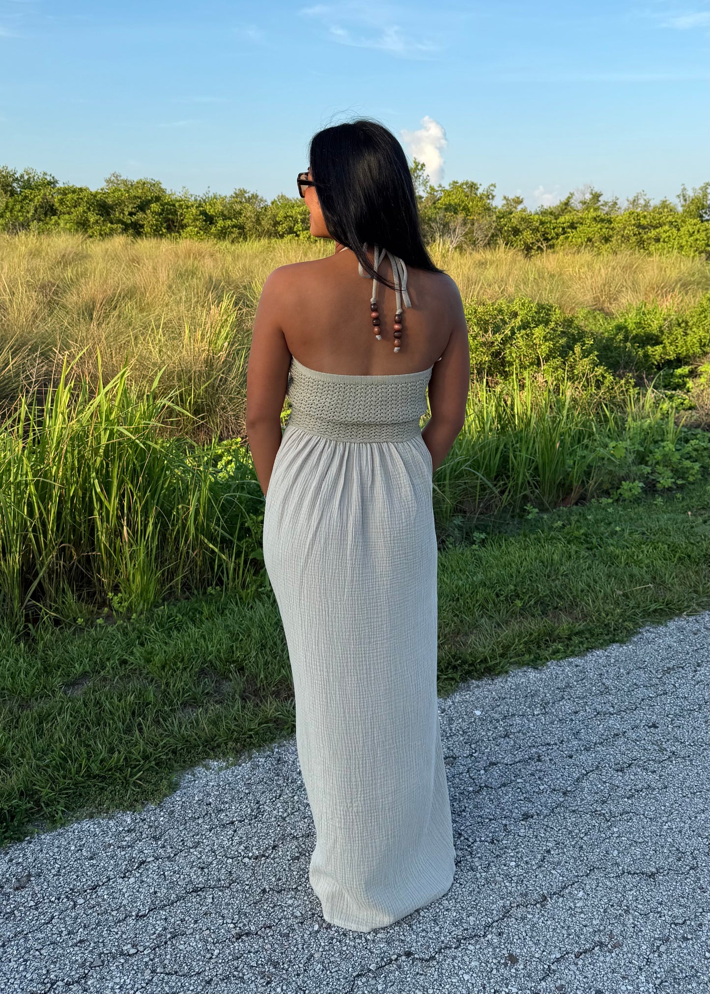woman wearing a long maxi dress on a grass background