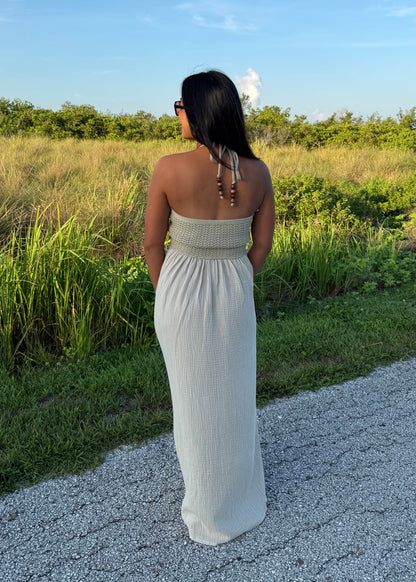 woman wearing a long maxi dress on a grass background