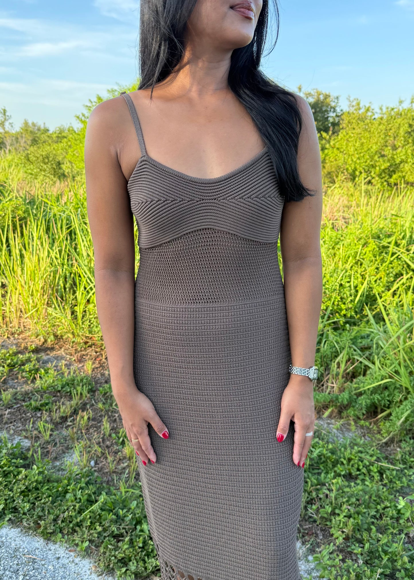 woman wearing a brown dress on a grass background