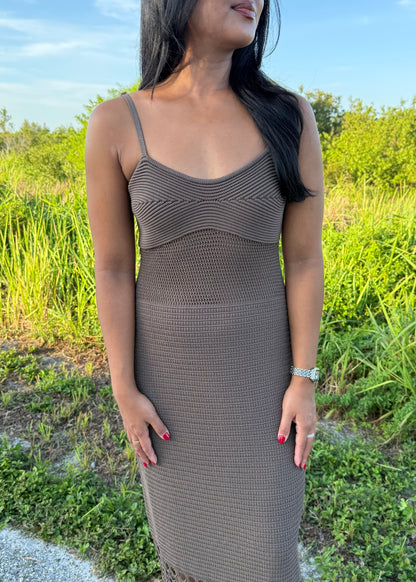 woman wearing a brown dress on a grass background