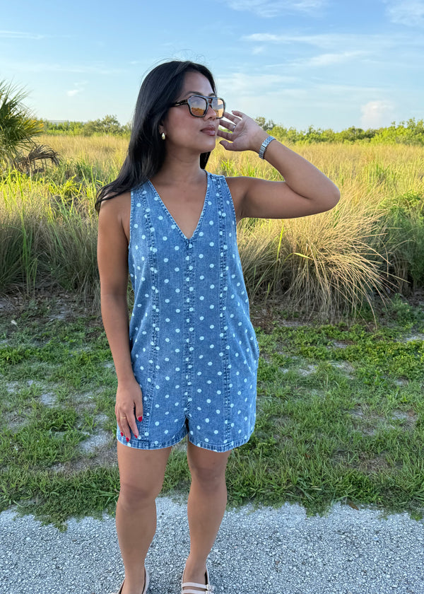 Girl wearing Millie Polka Dot Romper in Denim with grass background