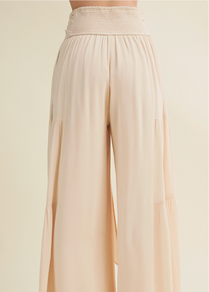 Beige wide-leg pants on a plain background