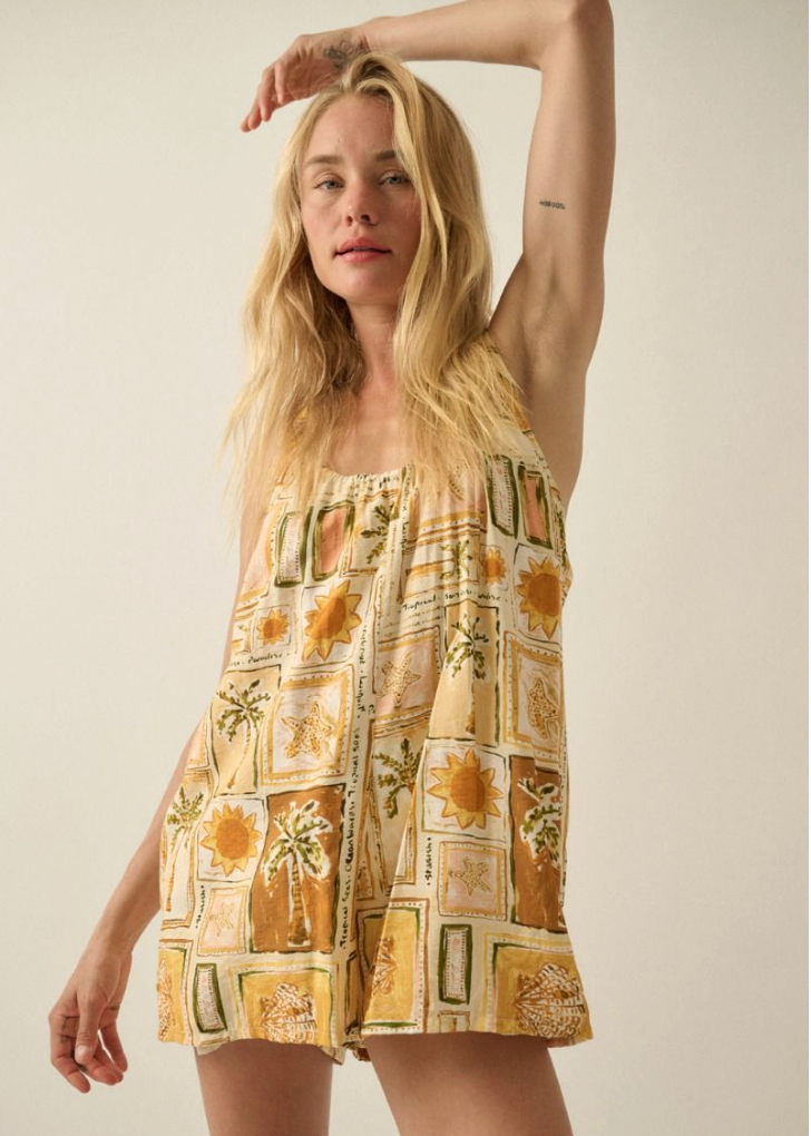 Woman wearing a patterned romper with a neutral background