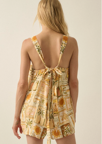 Woman wearing a patterned romper with a beige background